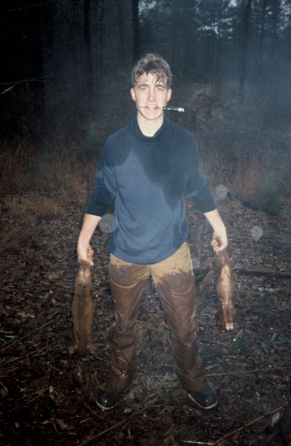 Watt Key as a teenager holding two small game animals